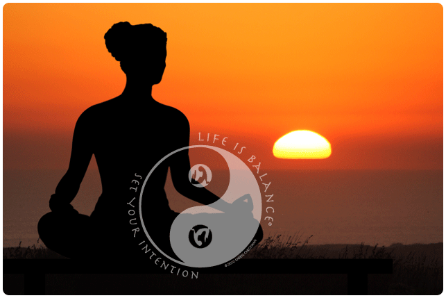 Yoga pose at sunset with Life is Balance yoga logo